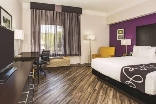 a hotel room with a bed and a desk at La Quinta by Wyndham Las Vegas Summerlin Tech in Las Vegas
