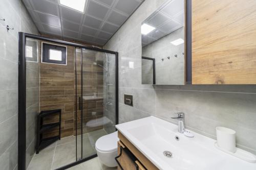 a bathroom with a sink and a shower and a toilet at Chic Flat with Central Location in Muratpasa in Antalya