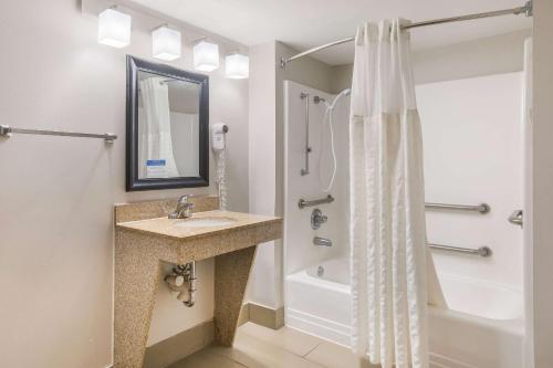 a bathroom with a sink and a shower at Clarion Pointe Forsyth I-75 in Forsyth