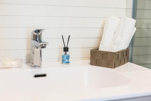 a bathroom counter with a sink with towels on it at Sorrento Tower in Sorrento