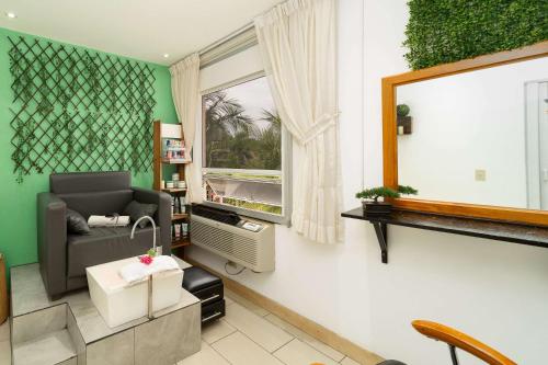 a living room with a couch and a window at Quality Hotel Real Aeropuerto San Salvador in San Luis