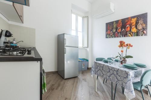 a kitchen with a table and a refrigerator at Sorrento Tower in Sorrento