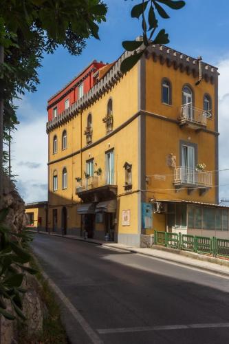 a large yellow building on the side of a street at Sorrento Tower in Sorrento