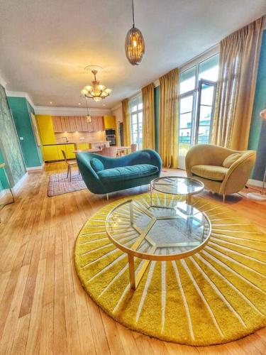 a living room with couches and a coffee table at St Nazaire Jardin des plantes superbe appartement in Saint-Nazaire