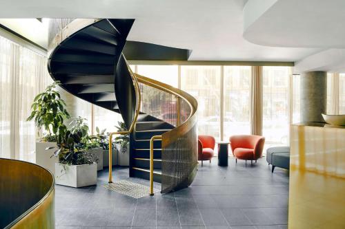 a lobby with a spiral staircase in a building at Quincy Hotel Melbourne in Melbourne