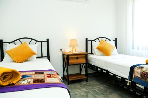 two beds sitting next to each other in a room at Villa-Sleeps 9-Parking-Pool-Bbq-Hot tub-Pets in Dalyan
