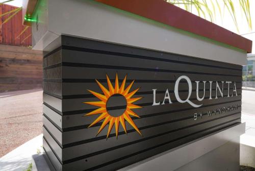a sign for a la union with a sun on it at La Quinta Inn & Suites by Wyndham Santa Cruz in Santa Cruz