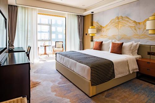 a hotel room with a large bed and a television at LDS Hotel Belgrade in Belgrade