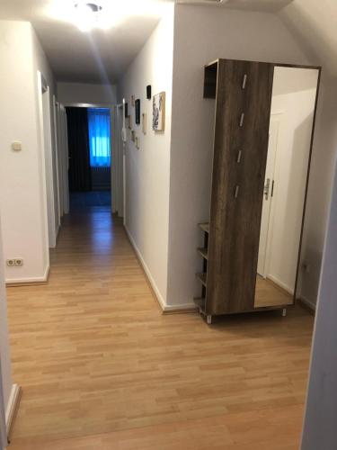 a hallway with a mirror and a wooden dresser at Ritfa 4 in Heide