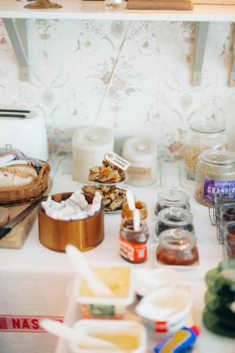 a table with many different types of food on it at Mormors Pensionat Strandhagen in Stora Rör