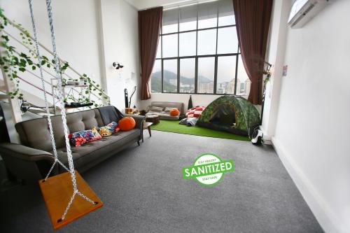 a living room with a couch and a swing at Private Forest Camp - Cinema, Hammock, Swing at CEO Penang in Bayan Lepas