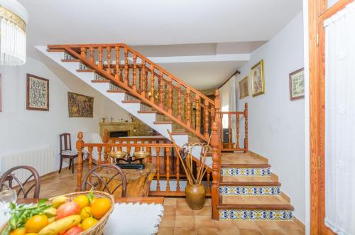 a wooden staircase in a living room with a bowl of fruit at Es Pujols in Campanet