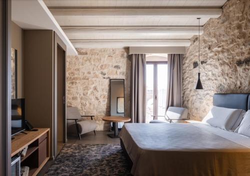 מיטה או מיטות בחדר ב-Pietra d'Acqua Resort & Spa by Geocharme