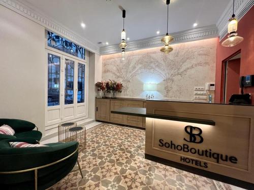 a hotel lobby with a bar and chairs and a counter at Soho Boutique Turia in Valencia