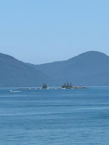 two islands in the middle of a large body of water at Cabana do Mar in Angra dos Reis