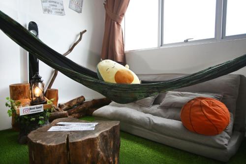 a hammock in a living room with a basketball at Private Forest Camp - Cinema, Hammock, Swing at CEO Penang in Bayan Lepas