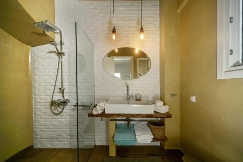 a bathroom with a sink and a mirror at Apeiron II Villa by PaxosRetreats in Oziás