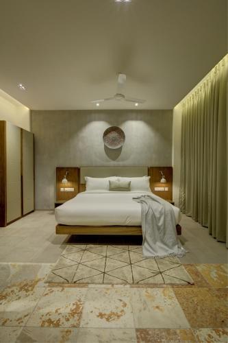 a bedroom with a large white bed in a room at Sopanam Heritage in Guruvāyūr