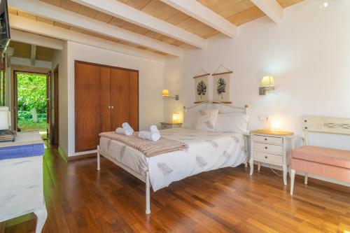 a bedroom with a large bed and a wooden floor at Ses Tendes in Algaida
