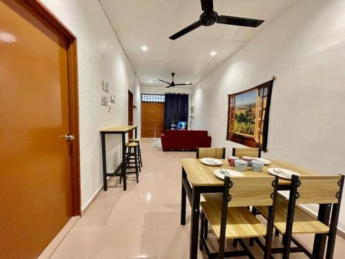 a dining room with a table and chairs at Cozy 255 Entire 3 Bedroom House At Alma Bukit Mertajam in Bukit Mertajam