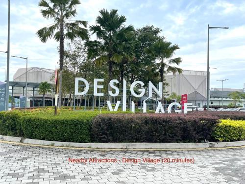 a sign in front of a building with palm trees at Cozy 255 Entire 3 Bedroom House At Alma Bukit Mertajam in Bukit Mertajam