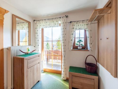 a kitchen with a large window and green floor at Friendly apartment in a dream location in Going am Wilden Kaiser in Going