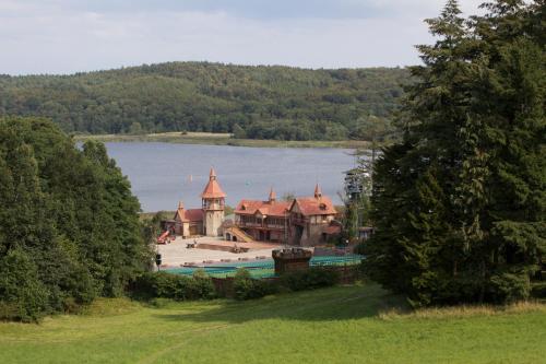 a house on the shore of a body of water at Schlosshotel Ralswiek in Ralswiek