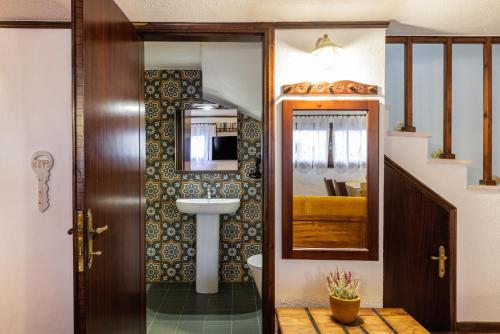 a bathroom with a sink and a toilet at Beach Front Vintage Villa Kalliktratis in Nea Kalikratia