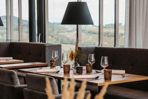 a restaurant with tables and chairs and a large window at Jaglhof in Gamlitz