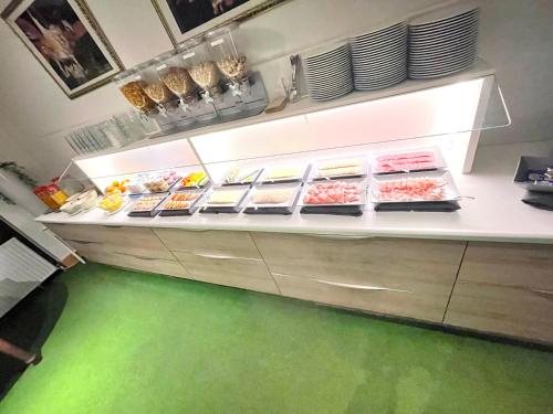 a kitchen with a counter with food on it at Rebgarten Hotel Schulgasse in Ravensburg