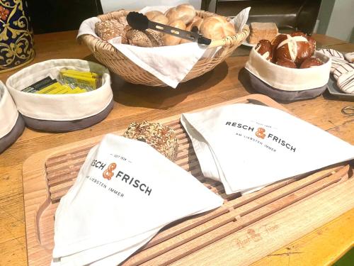 a table with baskets of bread and bags of food at Rebgarten Hotel Schulgasse in Ravensburg