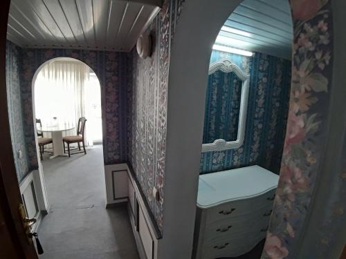 a dressing room with a mirror and a dresser at Hotel Turist in Chişinău