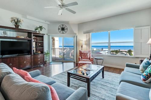 a living room with a couch and a table at Ocean View Arcane Condo in Fernandina Beach