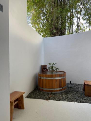 um quarto com um barril de madeira com uma planta em Le Sen Boutique Hotel em Luang Prabang