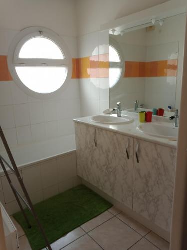 une salle de bain avec deux lavabos et un miroir dans l'établissement Villa perpignanaise, à Perpignan