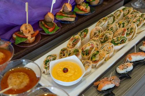 a buffet filled with different types of sandwiches and dips at Sol Cosmopolitan Rhodes in Ixia