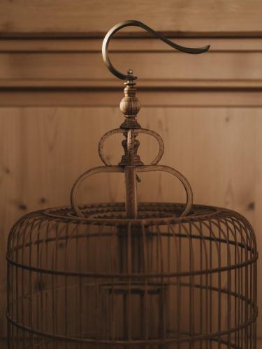 a bird cage with a hanger on top of it at Das Dietrich - Landhaus 58 in Leibnitz