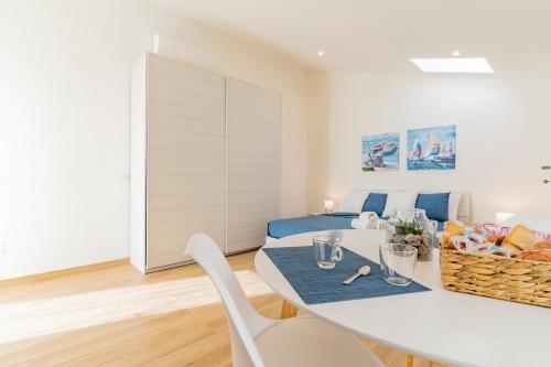 a living room with a table and chairs and a bed at Lumen House in Sassari