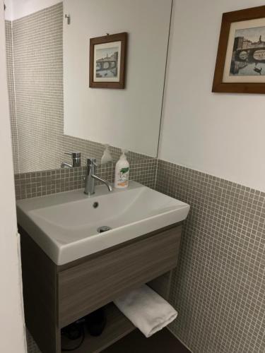 a bathroom with a sink and a mirror at A casa di nonno Peppe in Florence