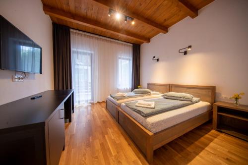 a bedroom with a bed and a large window at Castor in Harghita-Băi