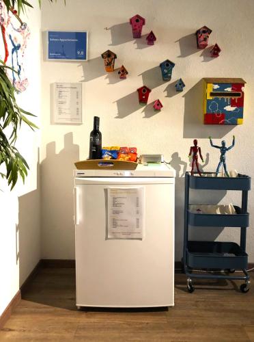 a refrigerator in a room with a wall with magnets at Schans Appartements in Hermagor
