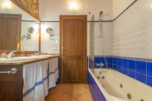 a bathroom with a tub and a sink and a shower at S'Era Nova in Algaida