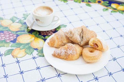 a plate of pastries and a cup of coffee at Hotel St. Giorgio in Castel San Giorgio