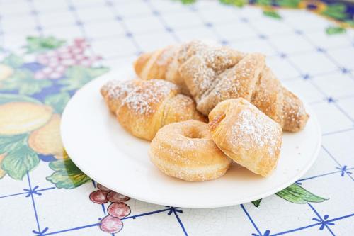 a white plate of donuts on a table at Hotel St. Giorgio in Castel San Giorgio