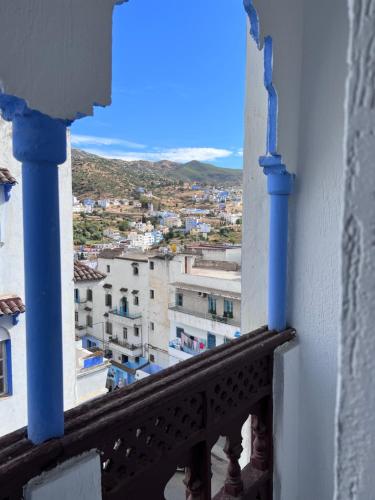 a view of a city from a balcony at Hotel Sevilla in Chefchaouene