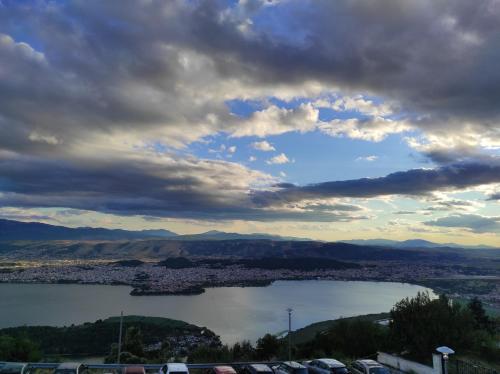 a view of a lake under a cloudy sky at 180 mountain lodge in Ioannina