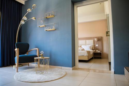 a room with a blue wall with a chair and a table at Hotel St. Giorgio in Castel San Giorgio