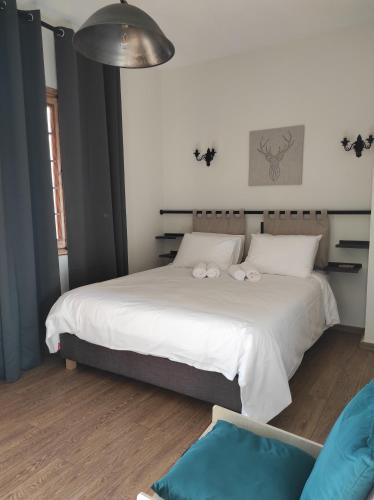 a bedroom with a bed with two towels on it at 180 mountain lodge in Ioannina