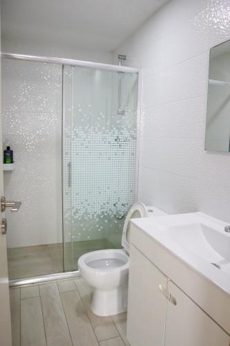 a bathroom with a shower and a toilet and a sink at Casa Fragosa - Alojamento local in Póvoa de Varzim