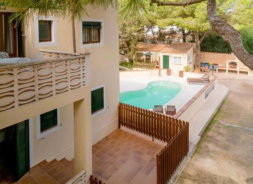 an external view of a house with a swimming pool at Apartamentos El Pino - Formentera Break in Es Calo